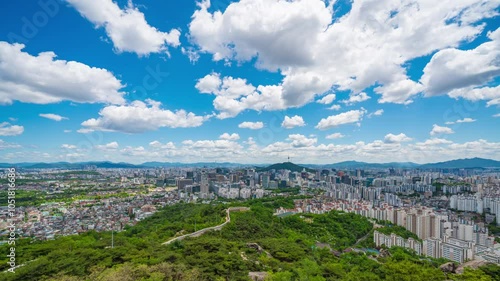 4K time lapse of Seoul's downtown cityscape beautifully cloudy day. Bright blue sky contrasts with the city's vibrant atmosphere, perfectly capturing the dynamic energy of the capital of South Korea