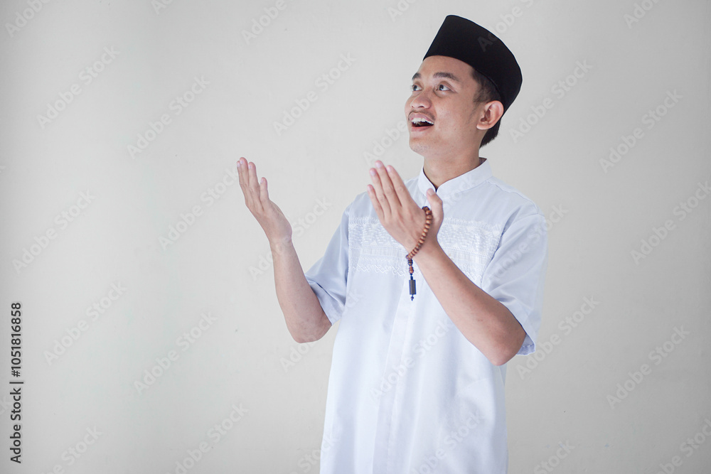Handsome and happy Asian Muslim man praying to God. Islamic concept. Handsome and happy Asian Muslim man praying to God. Islamic concept.