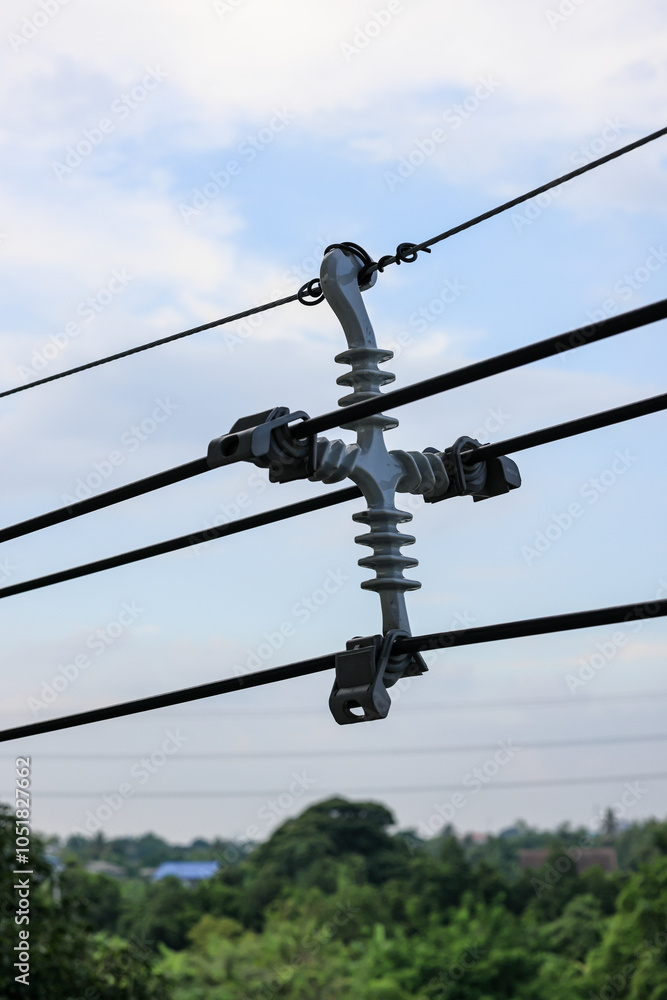 Four way metal power line spacer, Powerline separator, cable spacer and high voltage electric wire with blue sky background Four way metal power line spacer, Powerline separator, cable spacer and high voltage electric wire with blue sky background