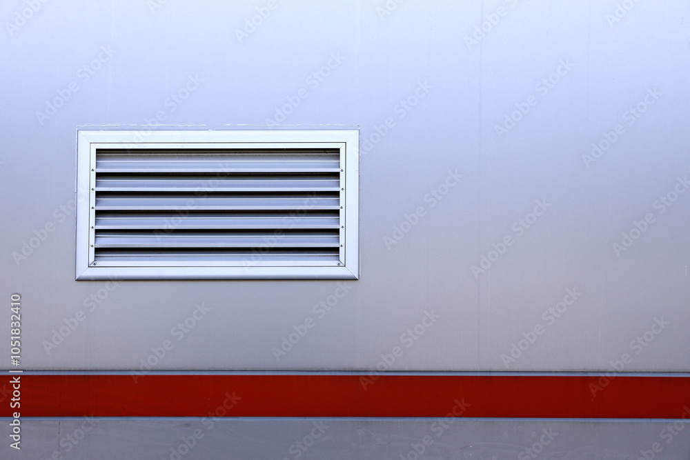 Air ventilator, metal slat frame on gray wall background. Air ventilator, metal slat frame on gray wall background.