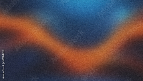 Abstract and modern design with blurred orange light on a grainy dark blue and black background