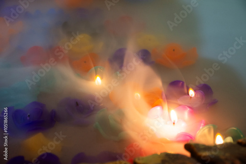 Ritual thai culture and traditional rite blessing with colorful candle flower floating in water for thai people travelers respect praying buddha at Wat Bua Khwan ancient temple in Nonthaburi, Thailand photo