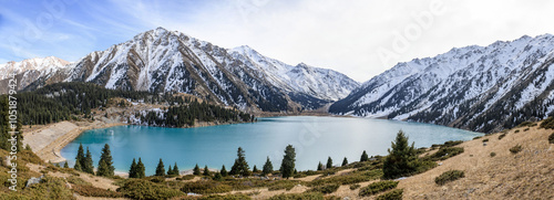 Beautiful mountain lake with ice and snow. Big Almaty lake in winter time. Kazakhstan.