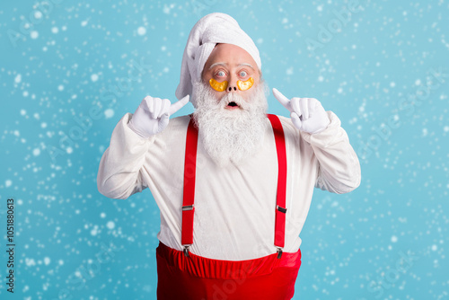 Photo of retired old man grey beard direct finger face excited look unexpected effect patch under eye wear santa x-mas costume towel turban suspender sunglass isolated blue color background photo