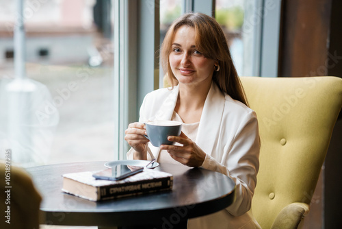 Elegant Woman Enjoying Coffee in a Cozy Cafe Setting Free Download Elegant Woman Enjoying Coffee in a Cozy Cafe Setting - GFXLoad