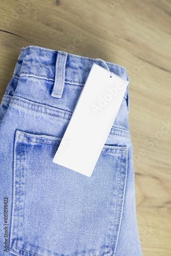 White empty clothing tag, label blank mockup for design on a jeans