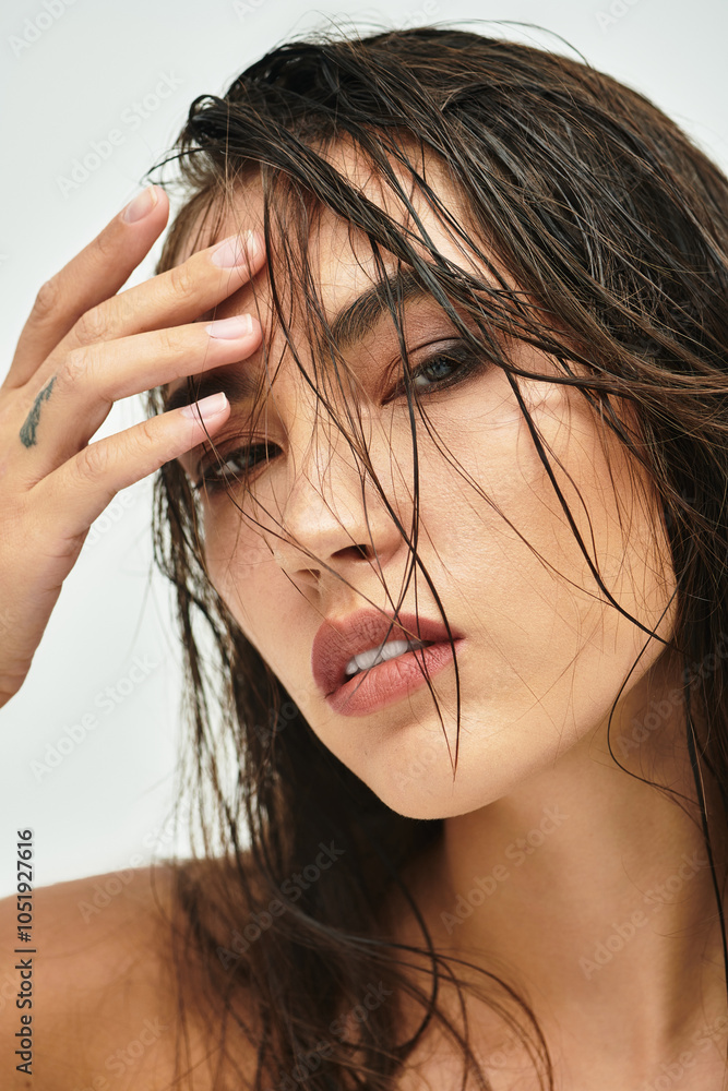 This striking image captures a woman with wet hair, exuding confidence and allure. This striking image captures a woman with wet hair, exuding confidence and allure.