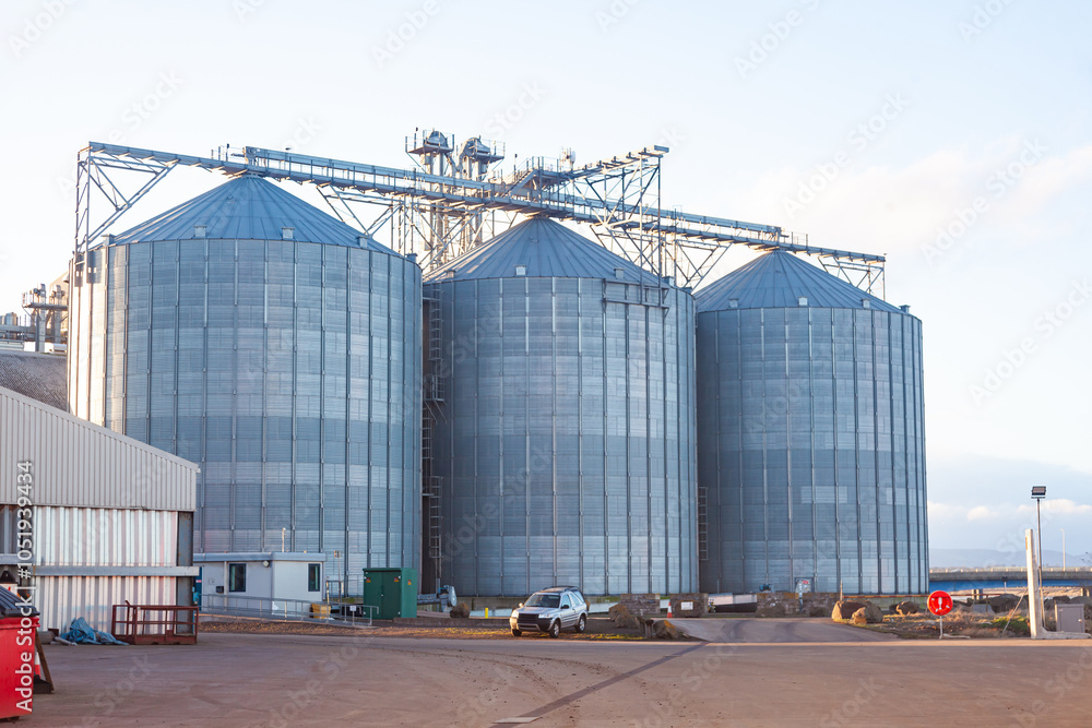 Grain storage terminal with tanks in a seaport. Grain storage terminal with tanks in a seaport.