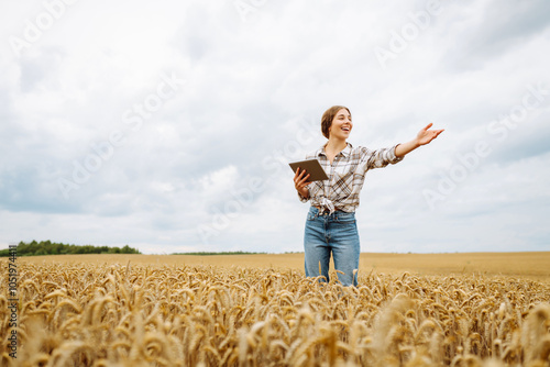 Smart farm. Growth dynamics. Young Female farmer with tablet in the field.