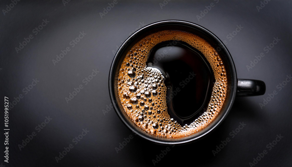Hot black coffee in black ceramic cup Top view of a freshly brewed cup of black coffee, with bubbles showing the intense aroma. background concept isolated dark black background Hot black coffee in black ceramic cup Top view of a freshly brewed cup of black coffee, with bubbles showing the intense aroma. background concept isolated dark black background