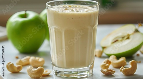Creamy Apple Cashew Smoothie With Green Apples on a Wooden Table