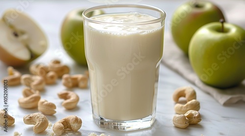 Creamy Apple Cashew Smoothie With Green Apples on a Wooden Table