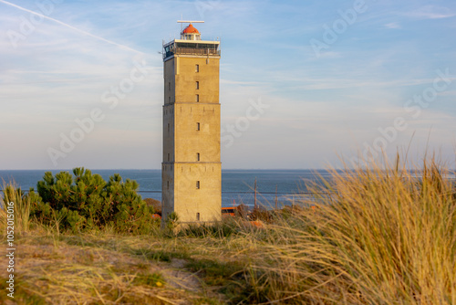 The Vuurtoren Brandaris (Lighthouse) under blue sky and white clouds, The Dutch Wadden Sea island Terschelling, A municipality and an island in the northern, Friesland, West-Terschelling, Netherlands. photo