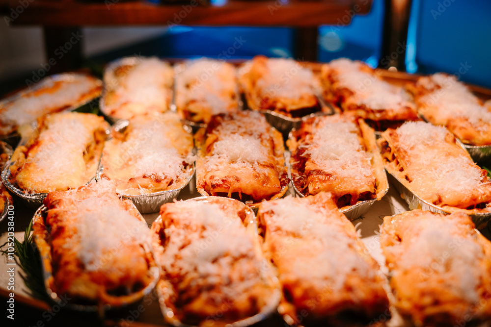 Mini lasagna servings arranged on a medium-sized tray Mini lasagna servings arranged on a medium-sized tray