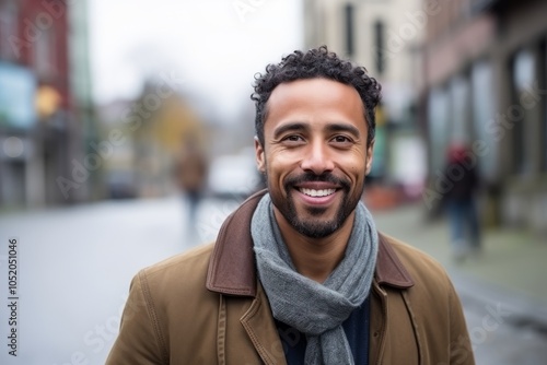 Portrait of a handsome man smiling at the camera in the city