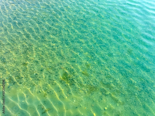 The clear waters of Issyk-Kul lake with a visible rocky bottom. Unique transparency and ecology of Kyrgyzstan s water bodies. photo