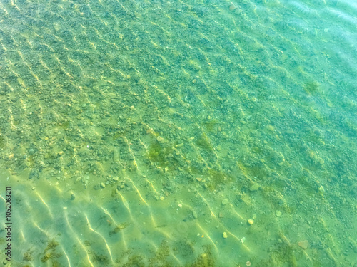 The clear waters of Issyk-Kul lake with a visible rocky bottom. Unique transparency and ecology of Kyrgyzstan s water bodies. photo