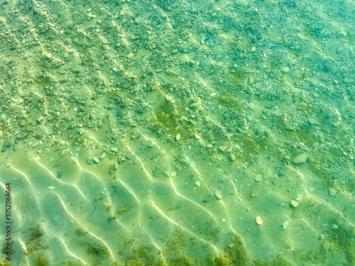 The clear waters of Issyk-Kul lake with a visible rocky bottom. Unique transparency and ecology of Kyrgyzstan s water bodies. photo