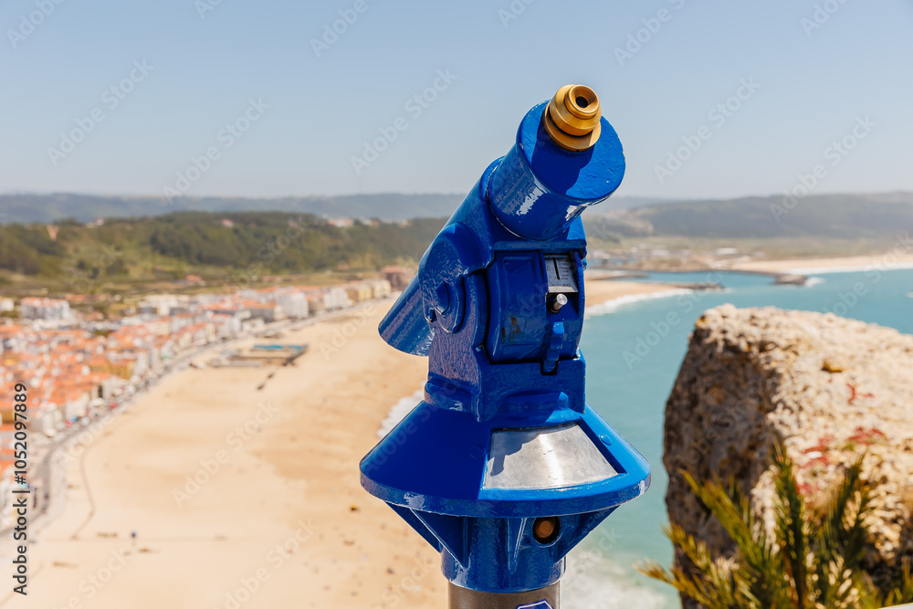 Blue telescope overlooking the bay of Nazare, Portugal