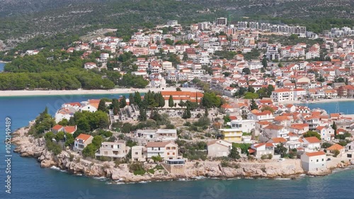 Aerial drone video of the coastal town and peninsula named Primosten in Croatia.