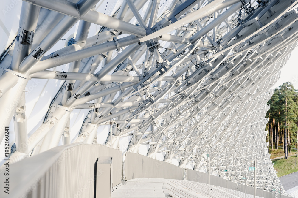 Fototapeta premium Modern architectural design featuring intricate structural elements at a unique outdoor venue surrounded by trees