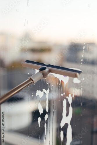 Window cleaning brush for windows. Washing windows with a window brush photo