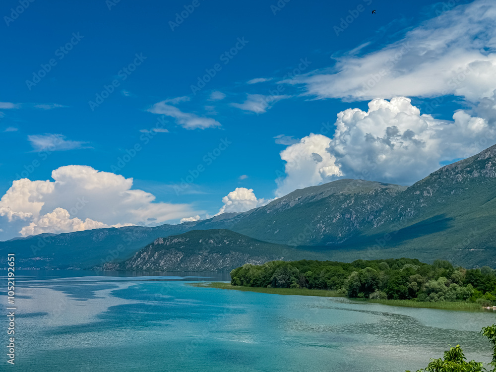 Breathtaking panoramic view of idyllic shore of Ohrid lake seen from St Naum monastery, North Macedonia. Surrounded by majestic mountains of National Park Galicica. Lush green hillsides. Mount Kota Breathtaking panoramic view of idyllic shore of Ohrid lake seen from St Naum monastery, North Macedonia. Surrounded by majestic mountains of National Park Galicica. Lush green hillsides. Mount Kota