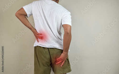 Fotografie Man feeling nerve pain from lower back and goes down to legs