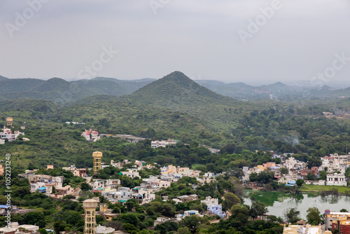 Scenic Aerial Cityscape at Mountain Base Under Cloudy Morning Sky