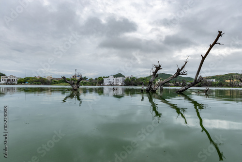 Serene Lake with Mountain View and Wood water Reflections Under Bright dramatic Sky at morning