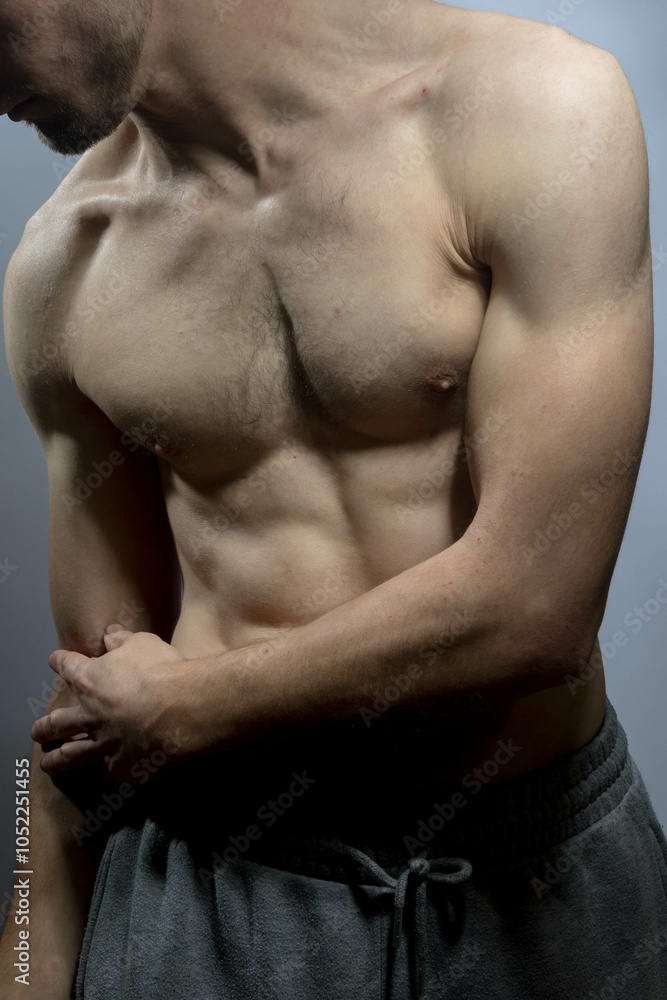 A young shirtless muscluar man