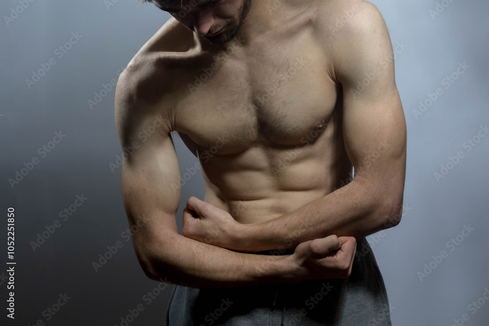 A young shirtless muscluar man A young shirtless muscluar man