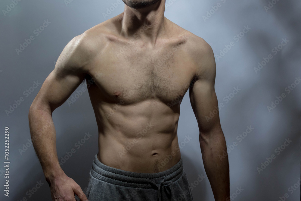Fototapeta premium A young shirtless muscluar man