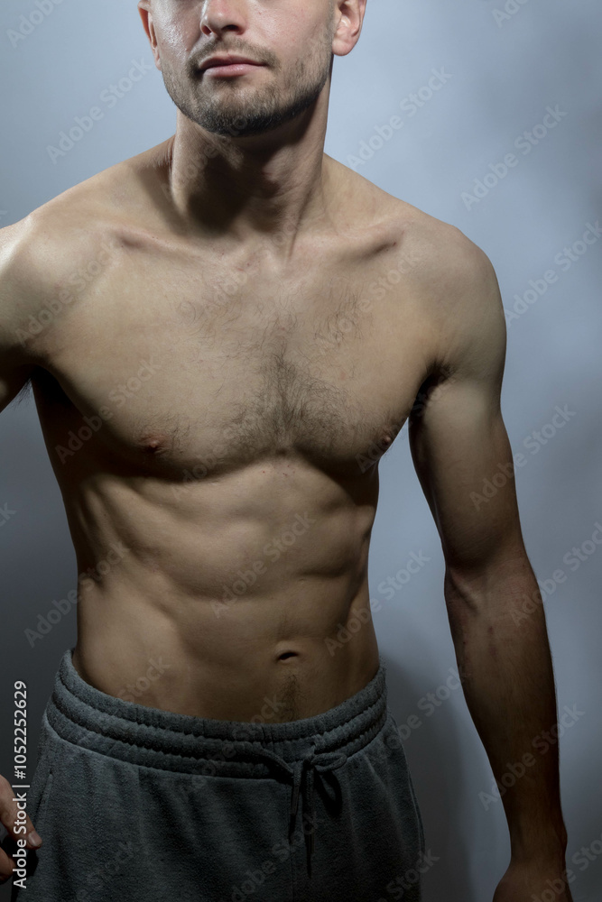 Obraz premium A young shirtless muscluar man