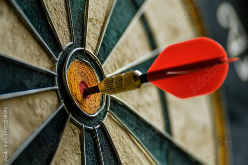 Bullseye: Dart hits center spot perfectly, surrounded by other darts on board. Concentration pays off in precision aim and skill. photo