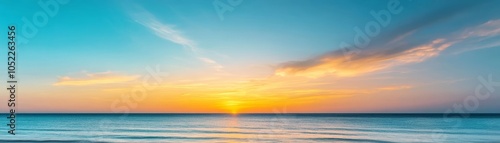 Dreamy summer sunset with radiant hues of yellow, orange, and blue, peaceful and calming skies over a tranquil ocean