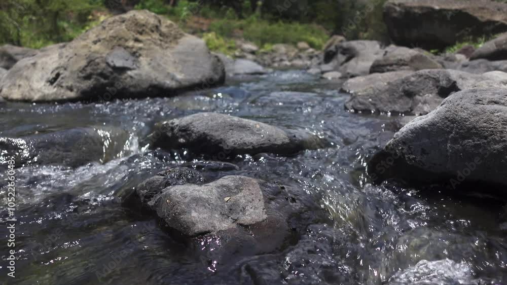 Fresh water flows down a beautiful cascade. Water flows on river rocks Fresh water flows down a beautiful cascade. Water flows on river rocks