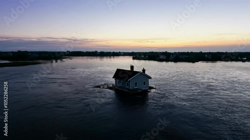 Wallpaper Mural A zoom-out shot of a solitary house surrounded by floodwaters at dusk, with only its chimney visible above the water, creating a scene of isolation and natural disaster

. Torontodigital.ca