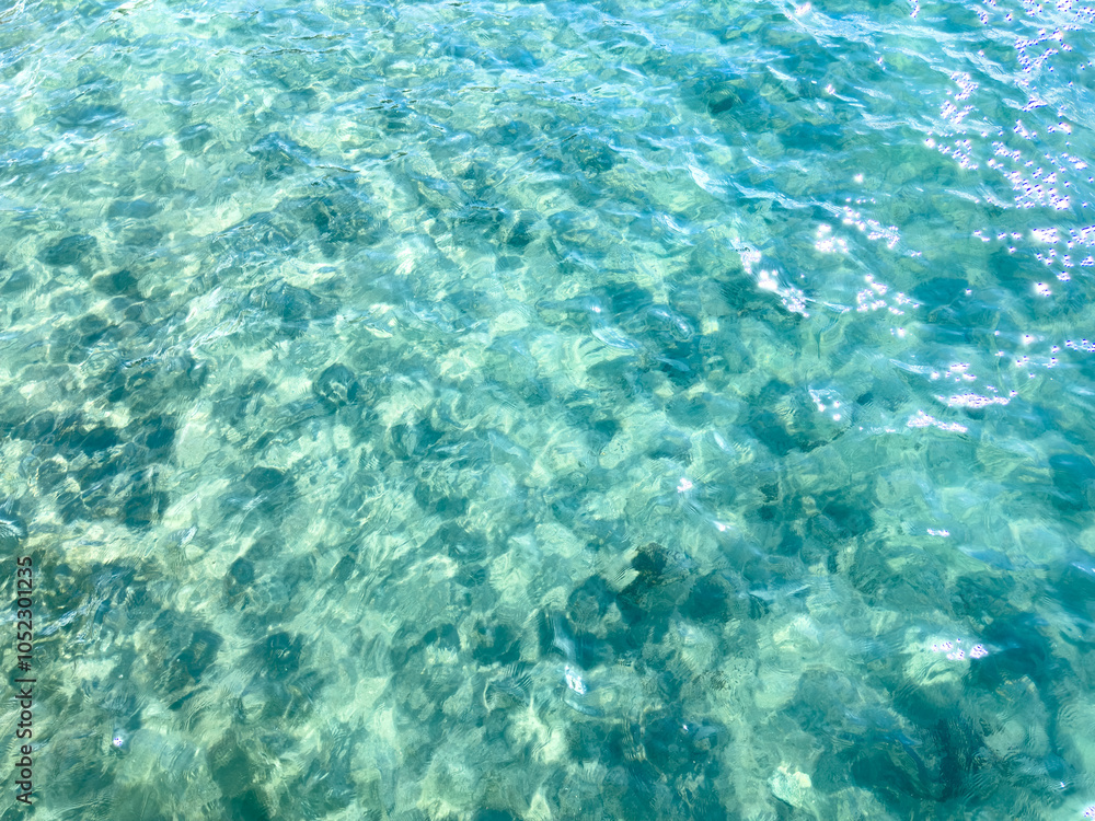Texture of blue calm water creates a serene and peaceful background. The natural beauty of water reflects the essence of nature, evoking a sense of tranquility reminiscent of the sea. Texture of blue calm water creates a serene and peaceful background. The natural beauty of water reflects the essence of nature, evoking a sense of tranquility reminiscent of the sea.