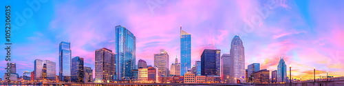 A city skyline with a purple sky in the background