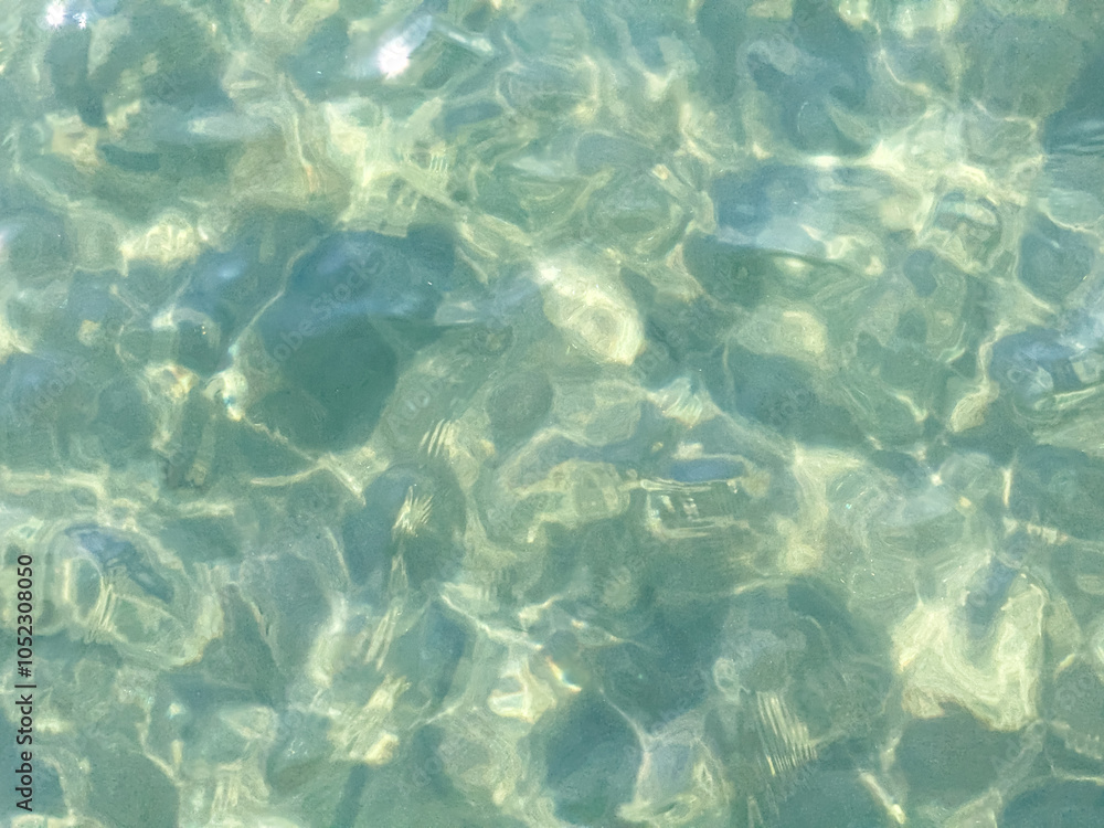 Fototapeta premium Texture of blue calm water creates a serene and peaceful background. The natural beauty of water reflects the essence of nature, evoking a sense of tranquility reminiscent of the sea.
