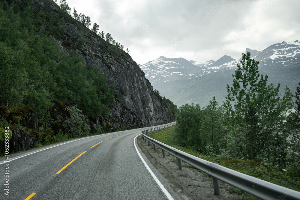Empty road in a moody norway mountain landscape Empty road in a moody norway mountain landscape
