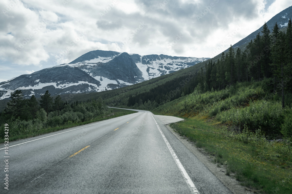 Empty road in a moody norway mountain landscape Empty road in a moody norway mountain landscape