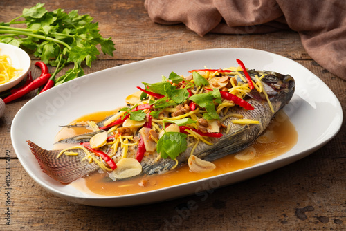 Steamed Tilapia fish with Soybean Paste sauce in white plate