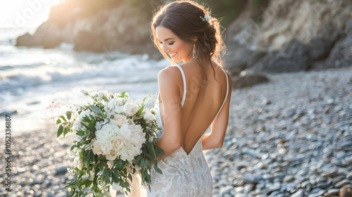 A serene moment captured of a bride holding a bouquet on a rocky beach during sunset. photo