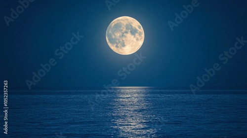 A full moon setting over a vast ocean, with its light stretching across the dark water.