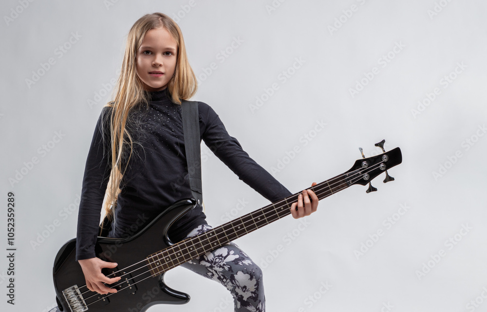 Fototapeta premium Young talented musician playing electric bass guitar on white ba