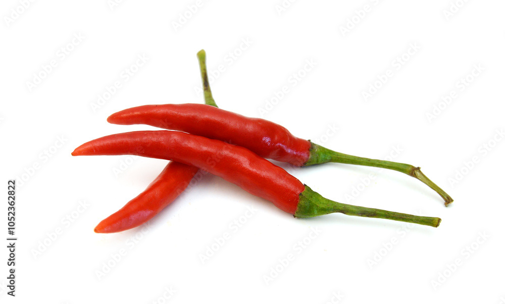 Stack red chili peppers and basil herb leaves on the white Stack red chili peppers and basil herb leaves on the white