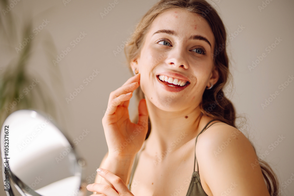 Beautiful woman looking in the mirror, touching her face with her hand. Pimples, acne, pores, scars. Natural skin without filters Beautiful woman looking in the mirror, touching her face with her hand. Pimples, acne, pores, scars. Natural skin without filters