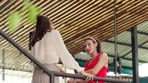 women talking on a balcony